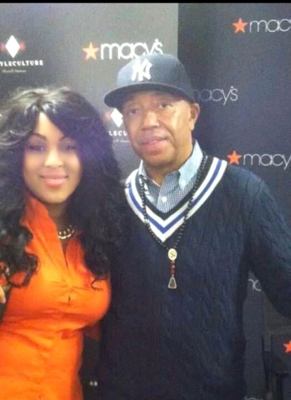 Two people photographed together in front of a Macy's event backdrop